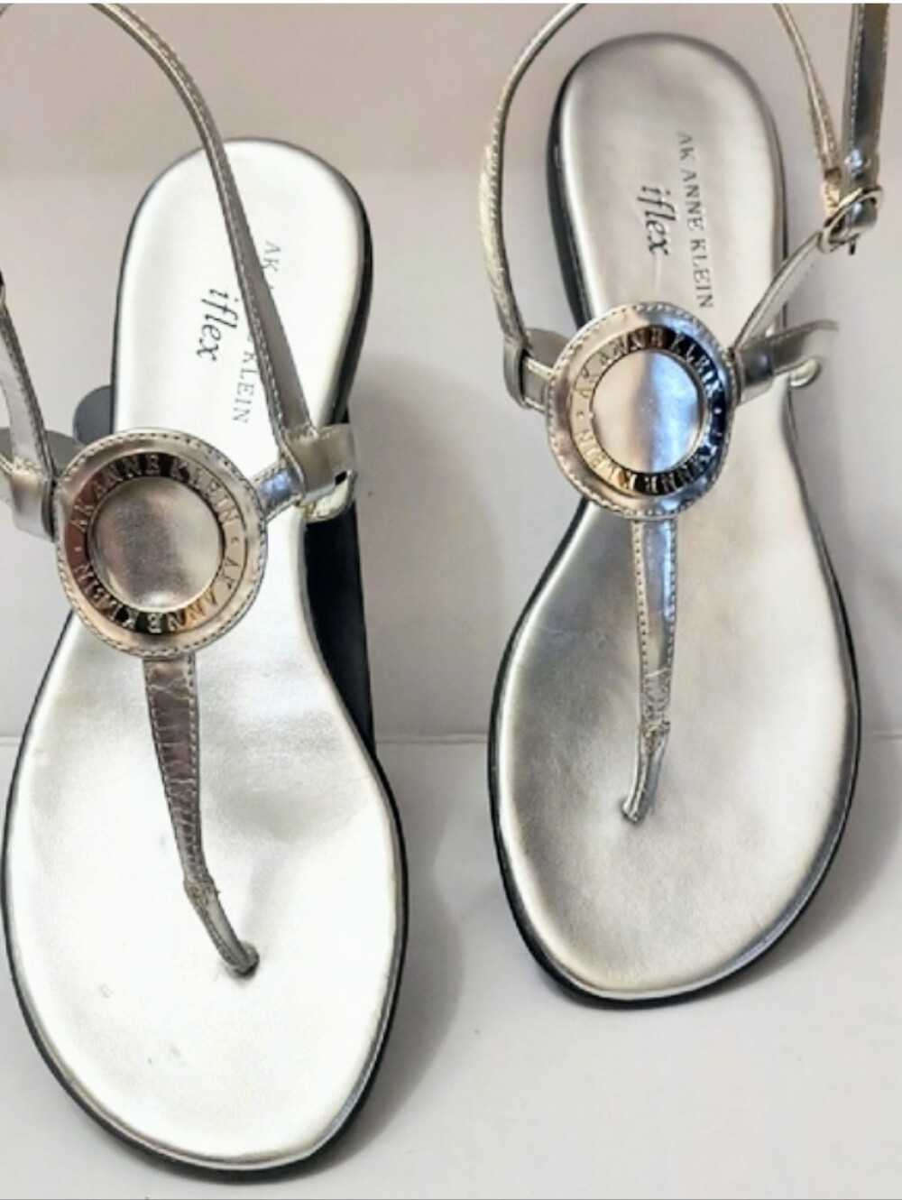 Anne Klein Metallic Silver Circular-Emblem T-Strap Sandals